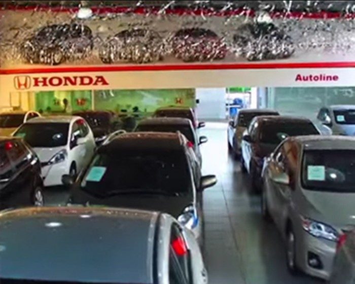 Salão de uma concessionária de carros com a fachada iluminada